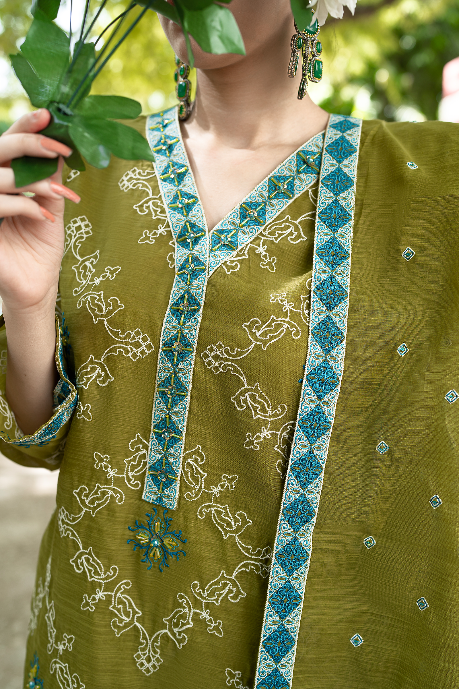 Close up of Hand Adda Work Crystals and Kut Dana on Olive Green Organza